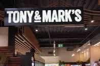 Interior of a store with 'TONY & MARK'S' branding on the ceiling.