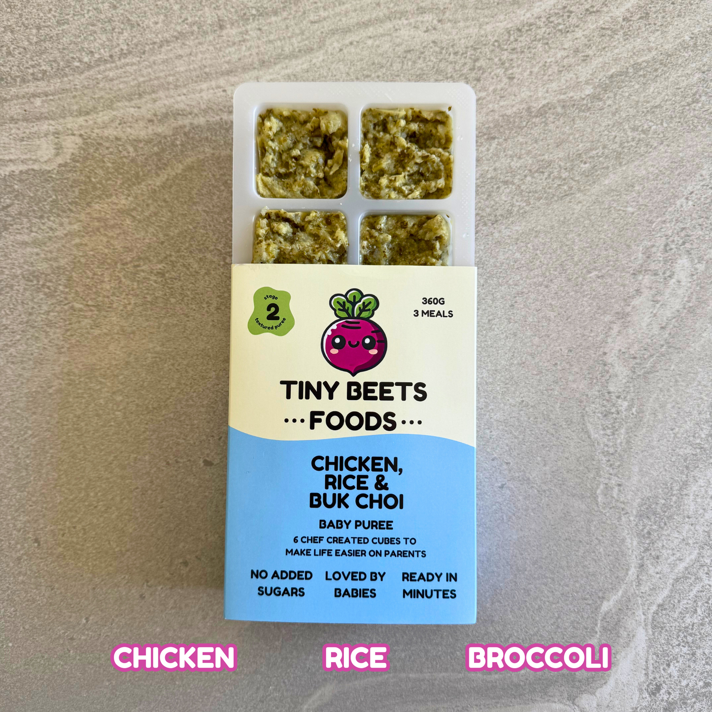Pack of Tiny Beets Foods baby puree cubes on a textured surface